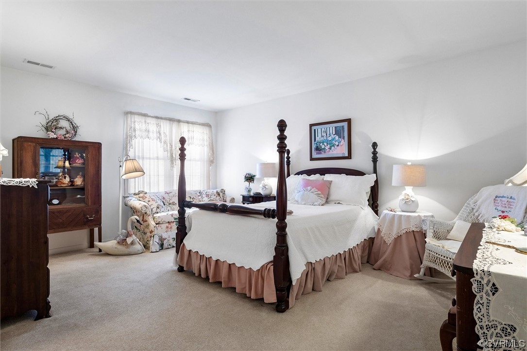 9508 Meadowview Road Henrico, VA 23294 - Photo 28 of 34 a spacious bedroom with a bed and a lamp on the dresser