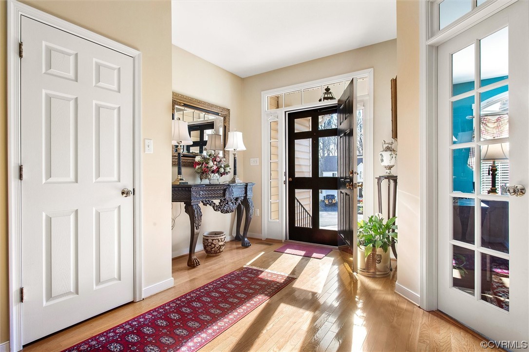 9508 Meadowview Road Henrico, VA 23294 - Photo 5 of 34 a view of a hallway with wooden floor and a livingroom with furniture