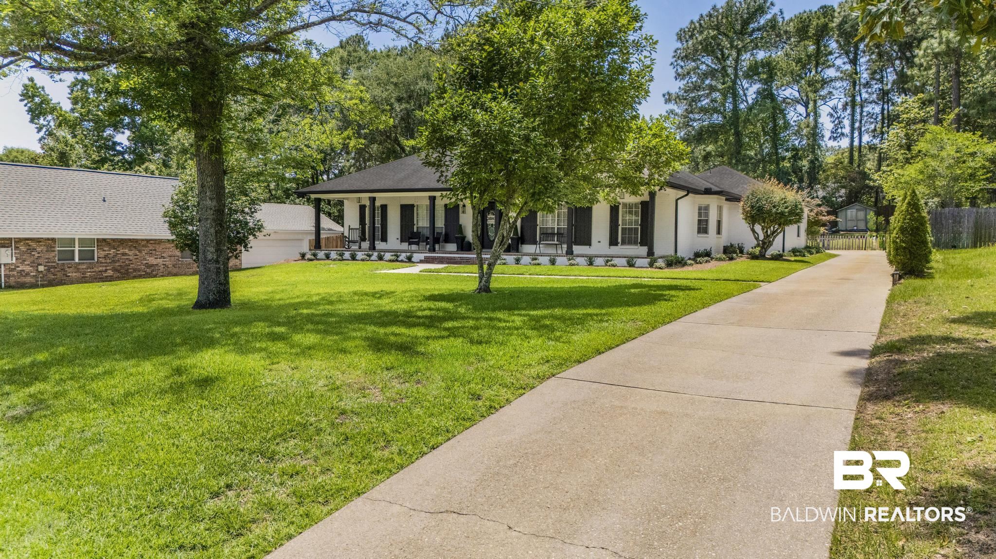 83 Caisson Trace Daphne, AL 36527 - Photo 3 of 63 White exterior with black shutters and a covered porch