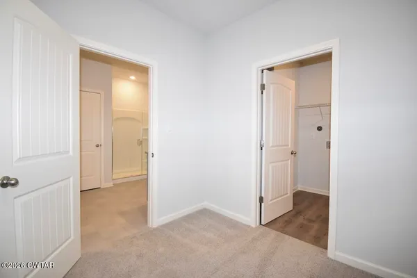an empty room that has a wooden door