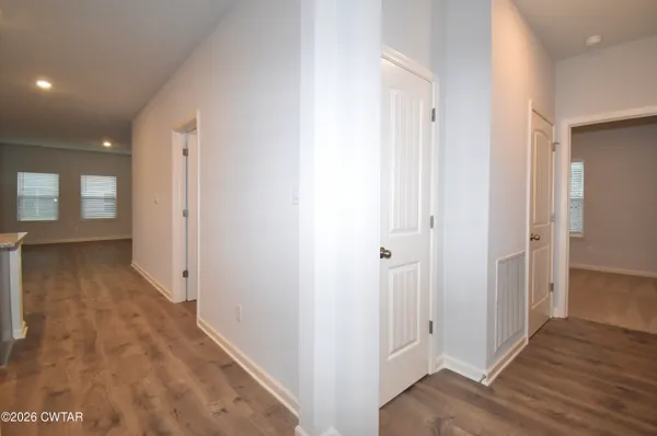 a view of a hallway with wooden floor