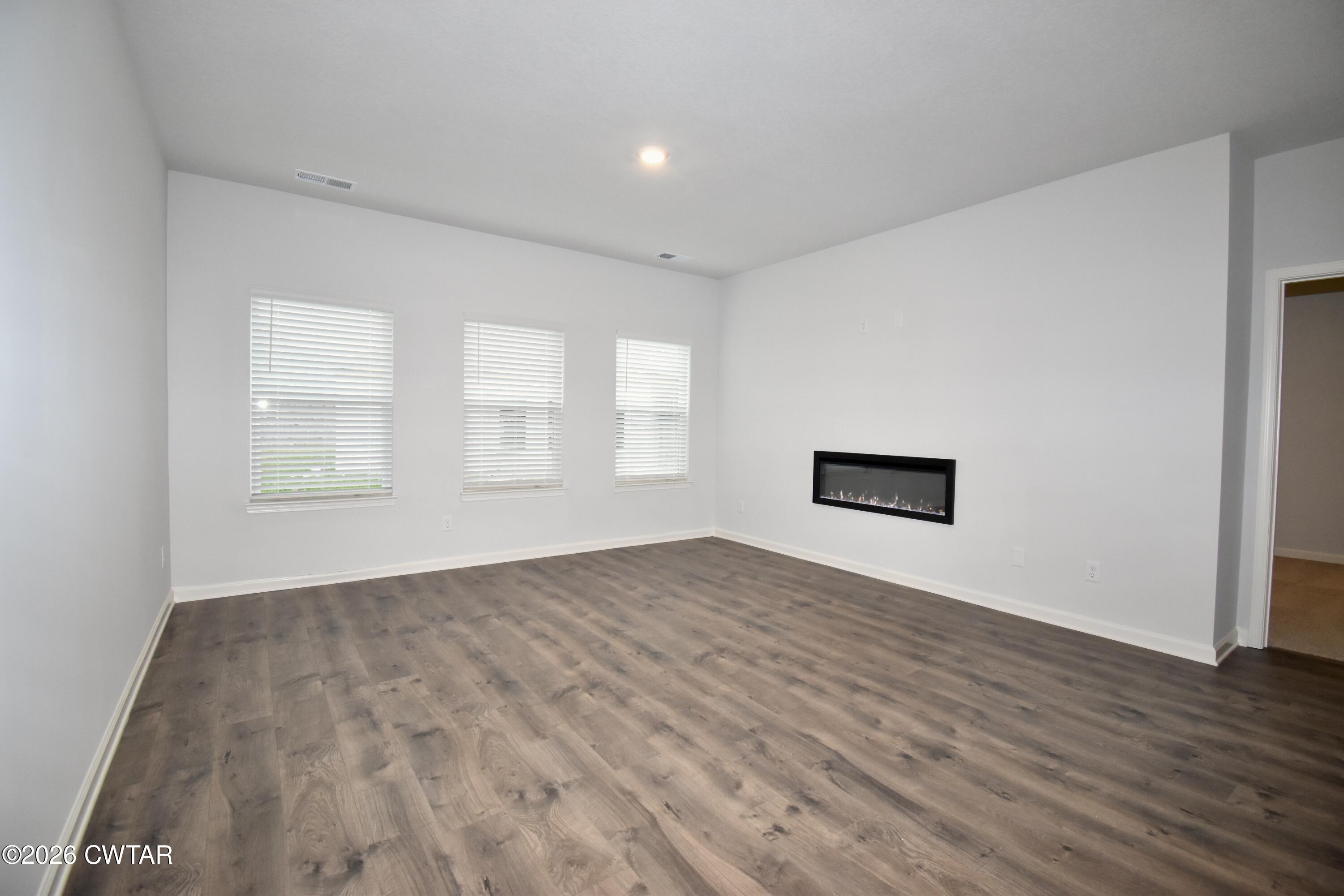 108 Gateway Drive Jackson, TN 38305 - Photo 2 of 21 a view of an empty room with wooden floor and a window