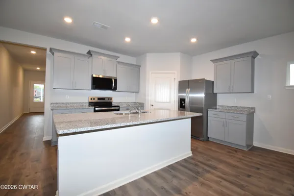 a kitchen with stainless steel appliances a refrigerator stove microwave and sink
