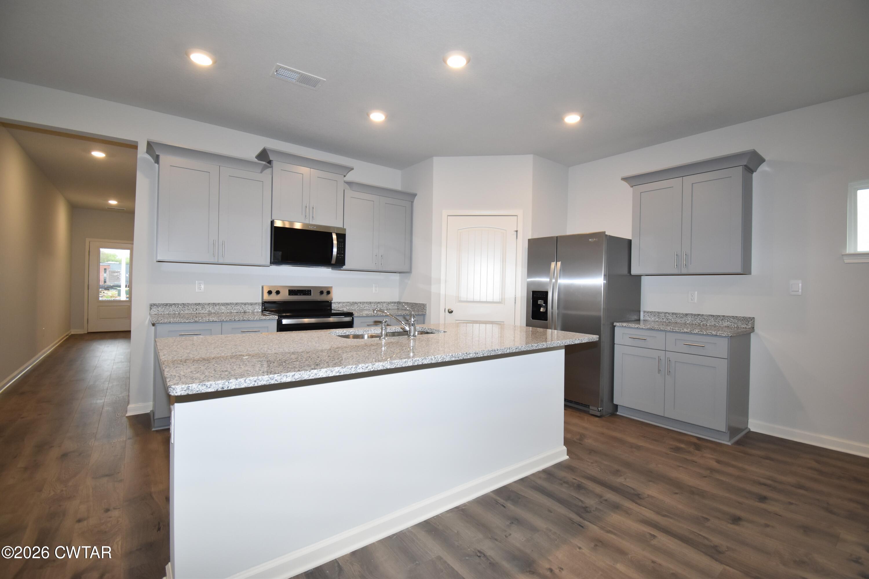 108 Gateway Drive Jackson, TN 38305 - Photo 3 of 21 a kitchen with stainless steel appliances a refrigerator stove microwave and sink