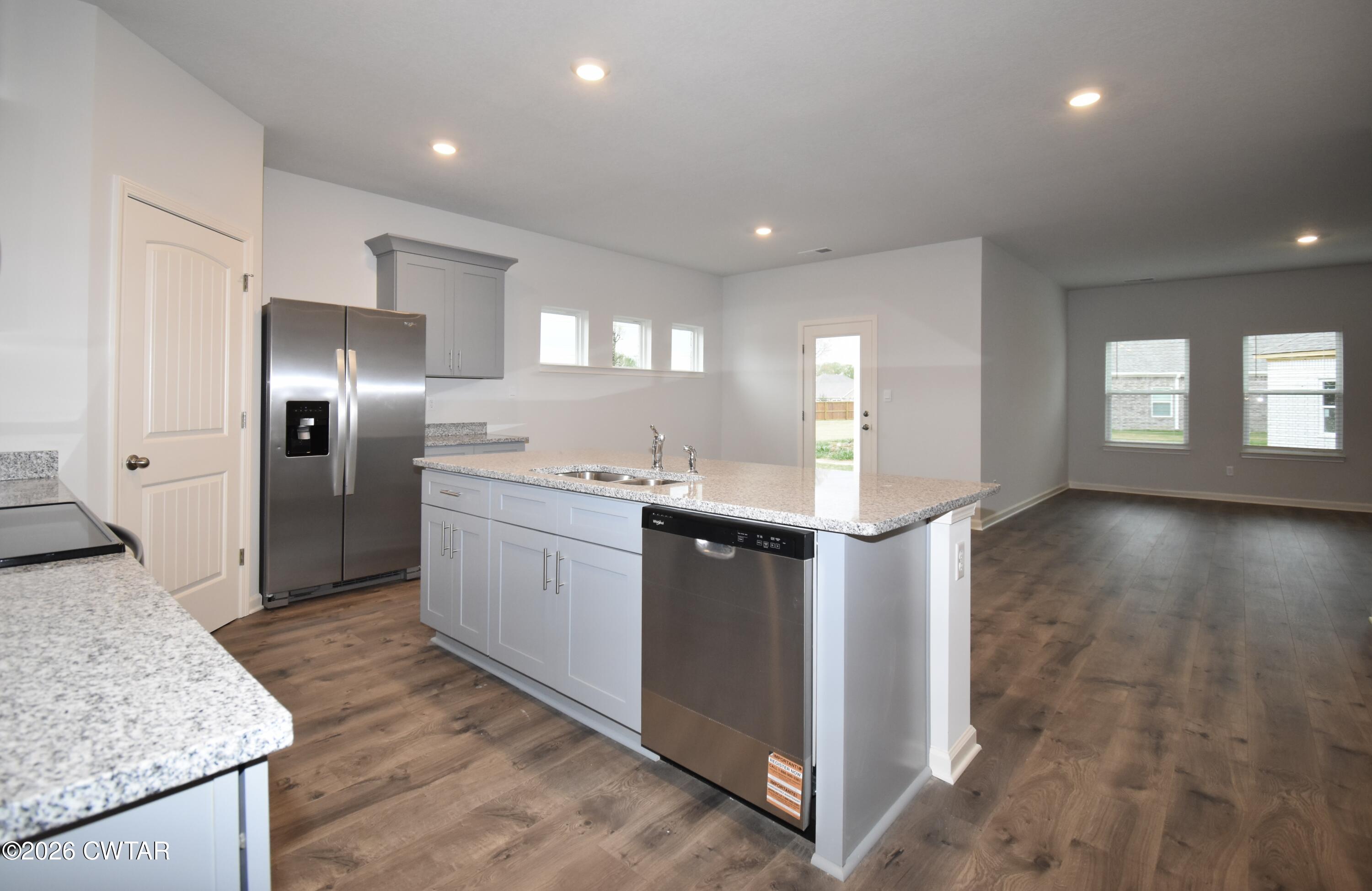 108 Gateway Drive Jackson, TN 38305 - Photo 4 of 21 a large kitchen with a refrigerator a sink a stove and cabinets