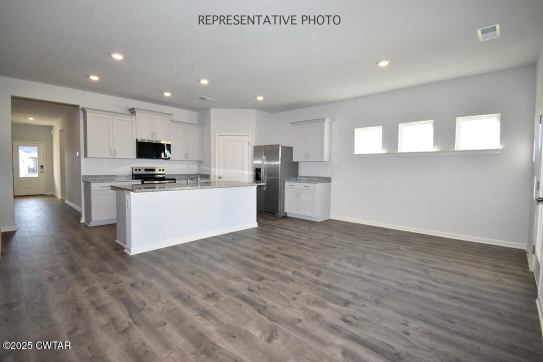 108 Gateway Drive Jackson, TN 38305 - Photo 5 of 19 a large kitchen with stainless steel appliances granite countertop a stove a sink and a microwave