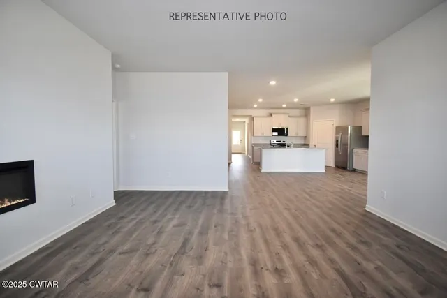 a view of a kitchen with a sink and a refrigerator