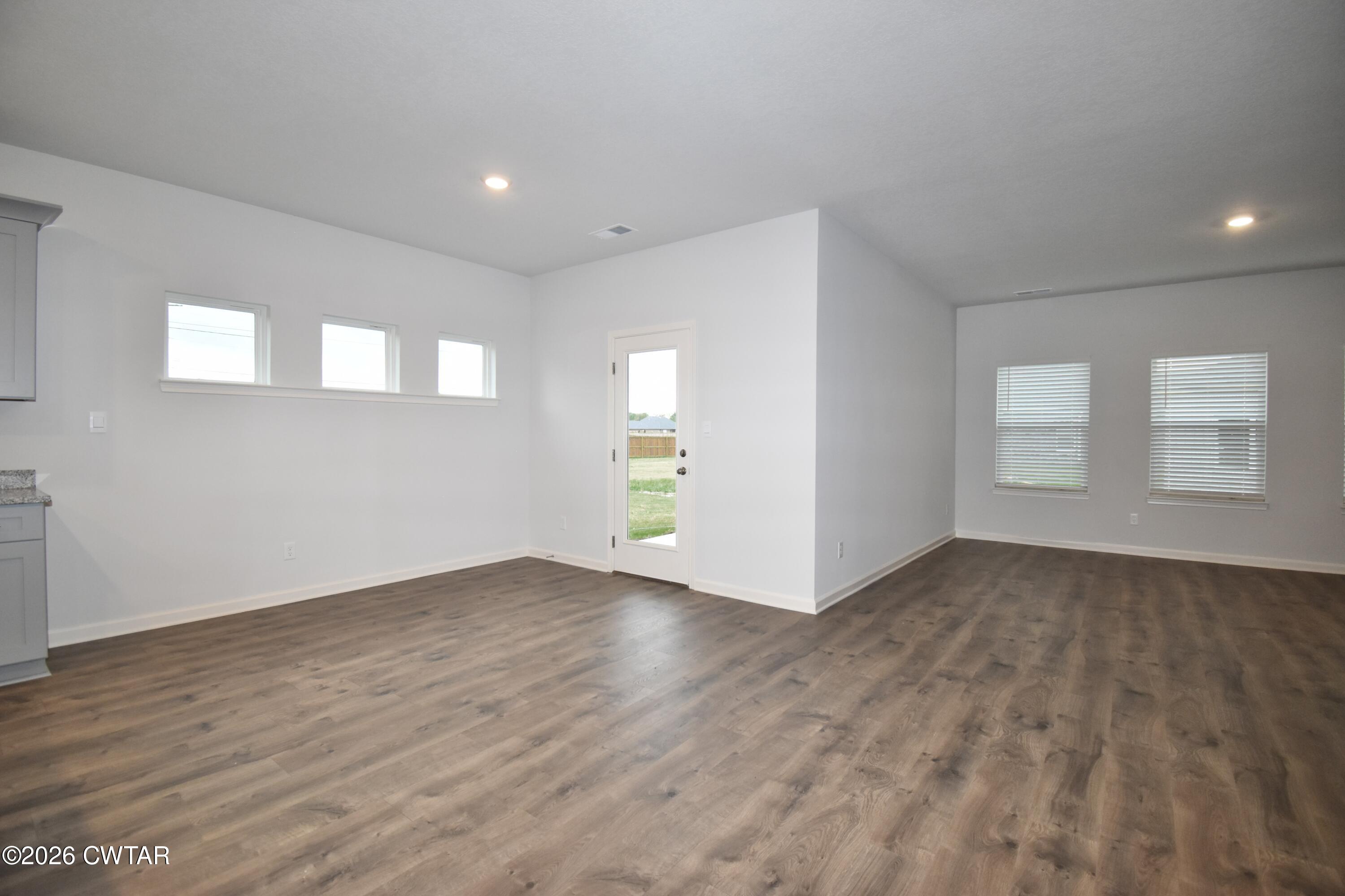 108 Gateway Drive Jackson, TN 38305 - Photo 7 of 21 an empty room with wooden floor and windows