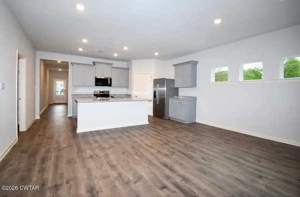 a view of a kitchen with a sink and a refrigerator
