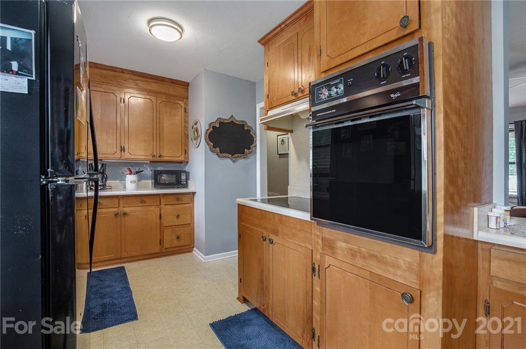 4025 Fallston Road Shelby, NC 28150 - Photo 12 of 29 a kitchen with stainless steel appliances a stove a microwave and sink