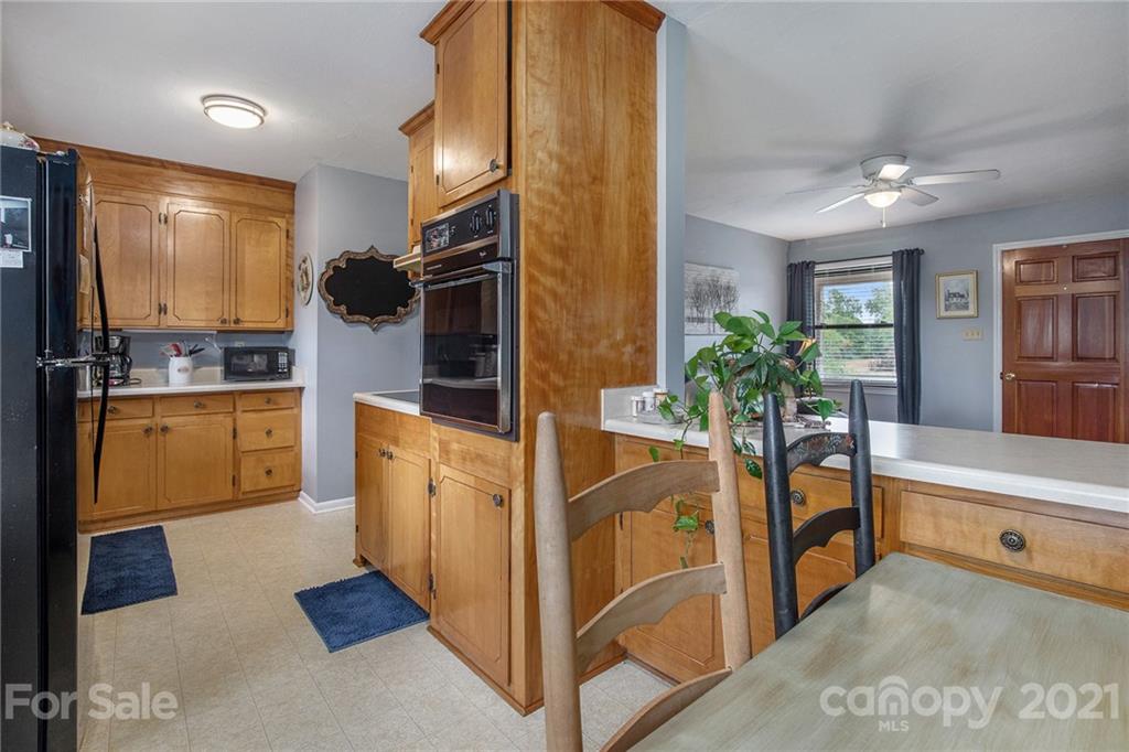 4025 Fallston Road Shelby, NC 28150 - Photo 15 of 29 a kitchen with stainless steel appliances kitchen island granite countertop a refrigerator a stove and a sink