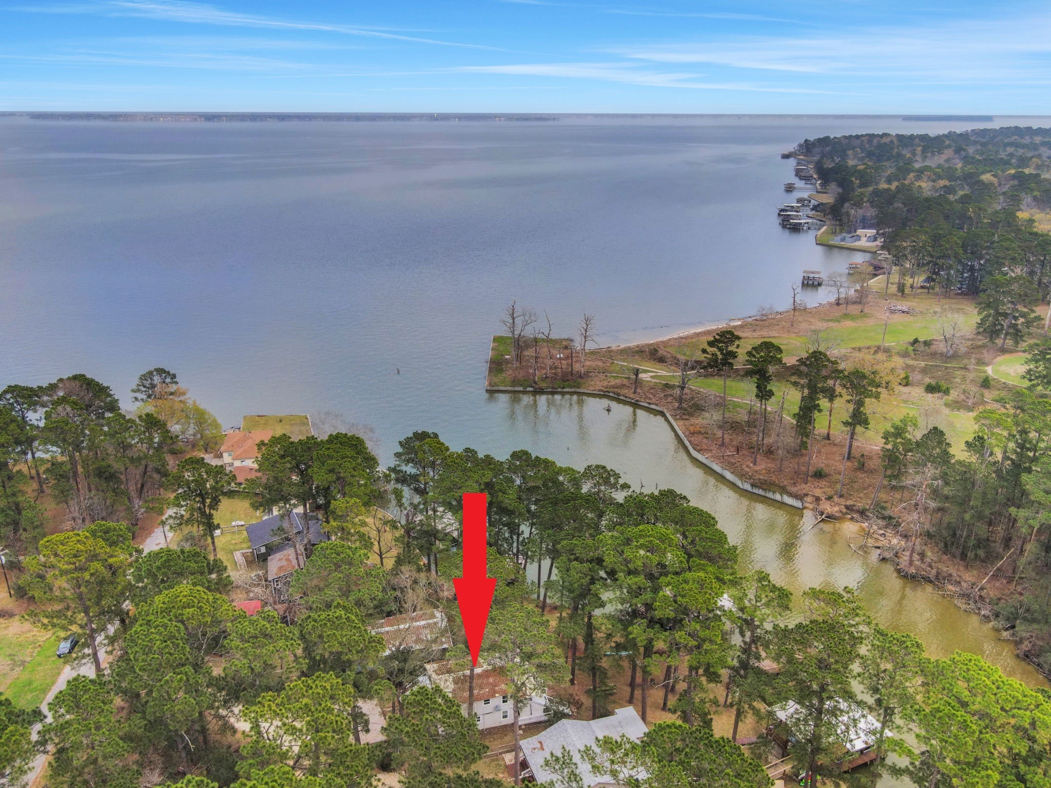 21 Red Bird Lane Coldspring, TX 77331 - Photo 2 of 37 This waterfront home is nestled amongst the trees and located across the cove from TRA owned lane (Cape Royale Golf Course)