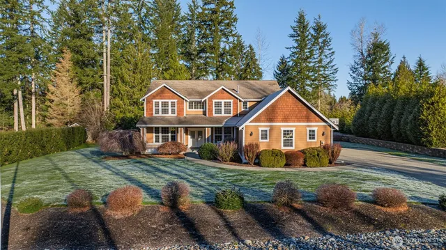 a view of a yard in front of a house with large trees
