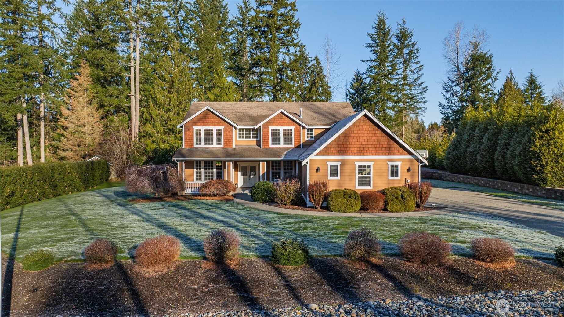 a view of a yard in front of a house with large trees