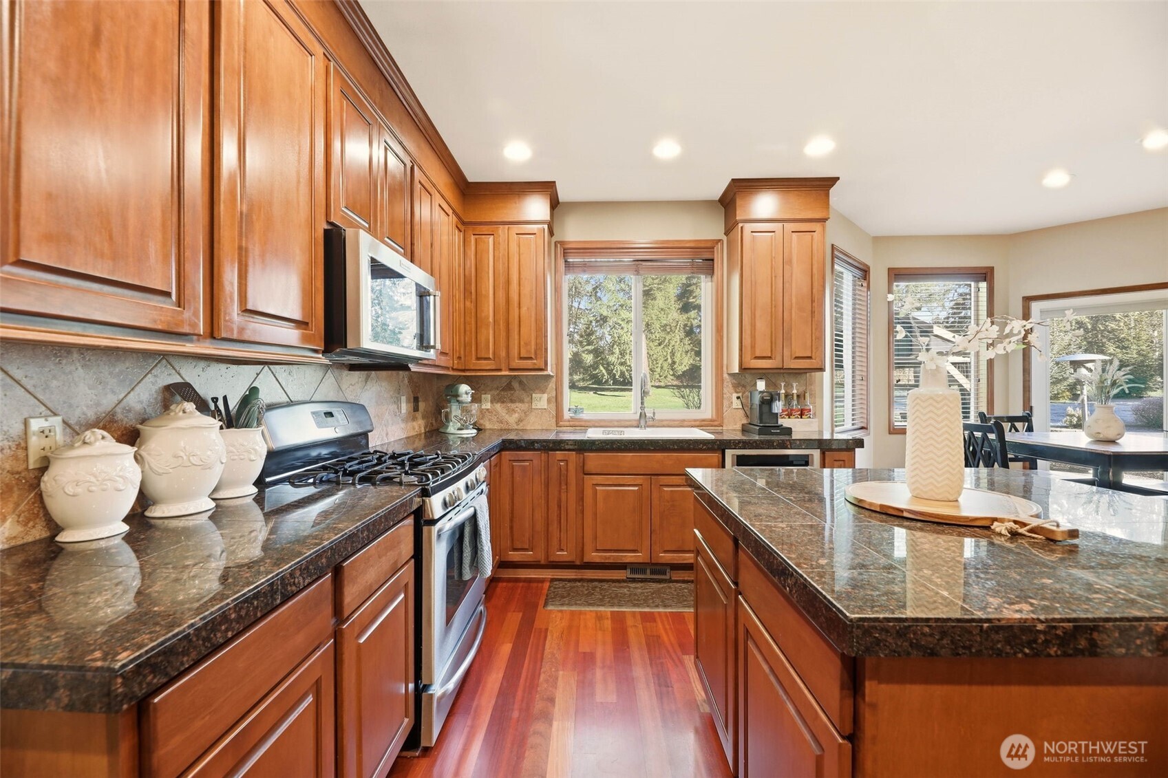 13621 3rd Street Southeast Snohomish, WA 98290 - Photo 9 of 38 a kitchen with stainless steel appliances granite countertop a sink a stove and a wooden cabinets