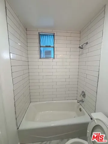 a bathroom with a bathtub and shower