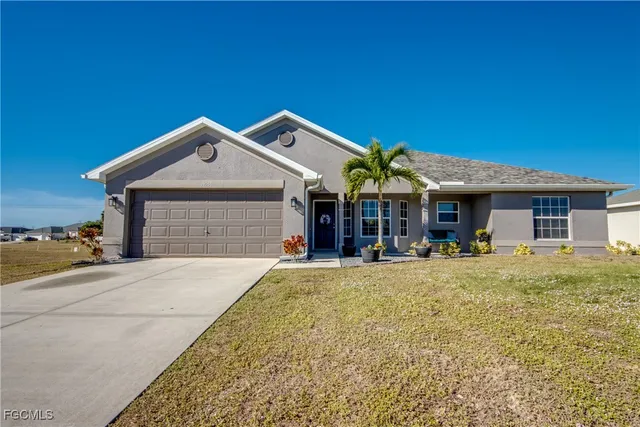 a front view of a house with yard patio and livingroom