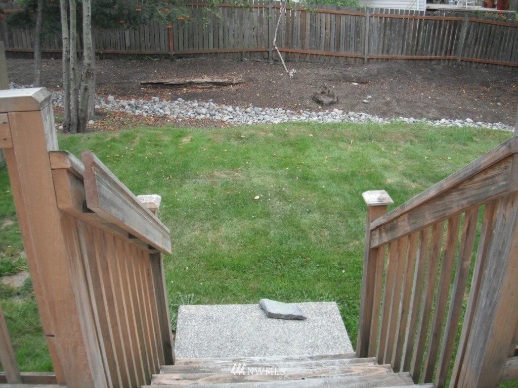 7522 Lower Ridge Road Everett, WA 98203 - Photo 6 of 6 a view of a backyard with a small cabin and wooden fence