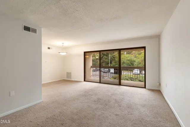 a view of an empty room with a balcony