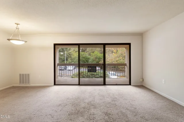 a view of an empty room with a balcony