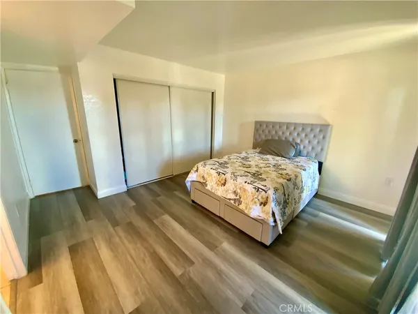 a bedroom with a bed and a mirror