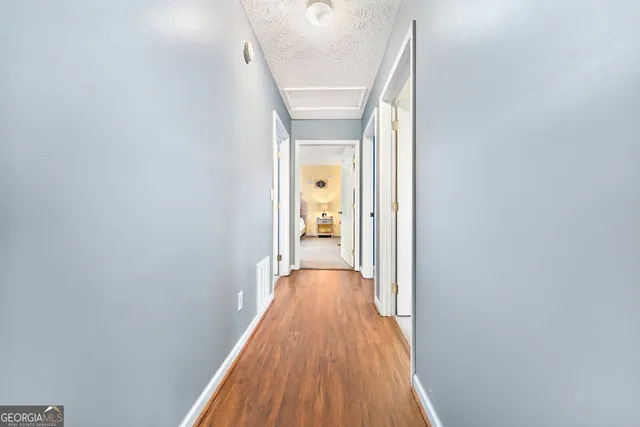 a view of a hallway with wooden floor and a hallway