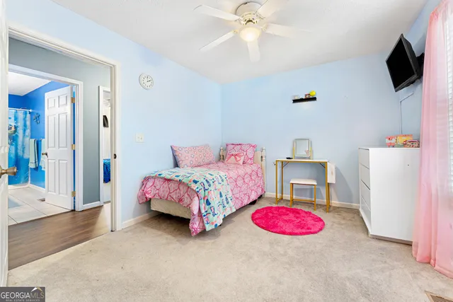 a bedroom with a bed and flat screen tv