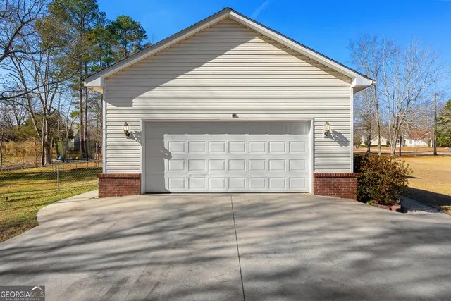 a view of a house with a yard and garage