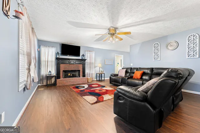 a living room with furniture fireplace and flat screen tv