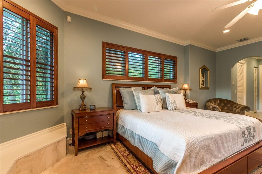 17611 Southwest 48th Street Southwest Ranches, FL 33331 - Photo 16 of 55 a bedroom with a bed and a night stand