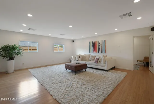 a living room with furniture and a potted plant