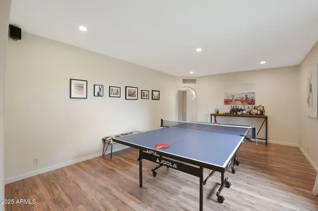 a view of a workspace with furniture and wooden floor