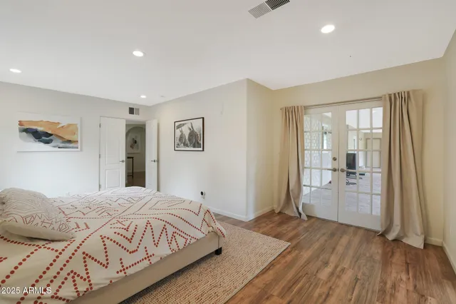 a bedroom with a bed and a lamp