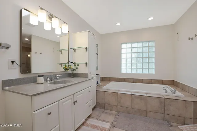 a bathroom with a granite countertop sink a toilet and a mirror