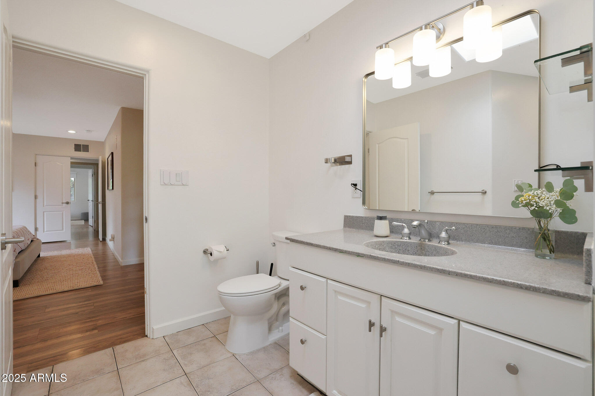 2226 East Fairmount Avenue Phoenix, AZ 85016 - Photo 29 of 50 a bathroom with a granite countertop sink a toilet and a mirror