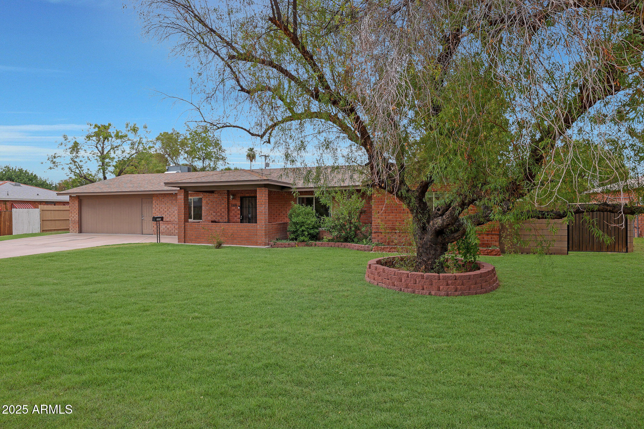 2226 East Fairmount Avenue Phoenix, AZ 85016 - Photo 3 of 50 a front view of a house with a garden