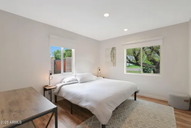 a bedroom with a bed and a painting on the wall