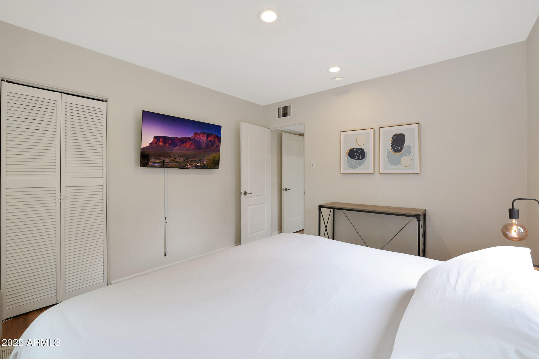 2226 East Fairmount Avenue Phoenix, AZ 85016 - Photo 34 of 50 a bedroom with a large bed and a flat screen tv