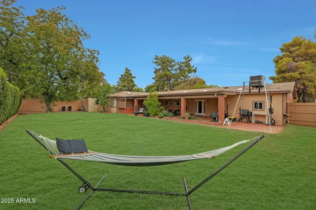 a view of backyard with cabin and wooden fence