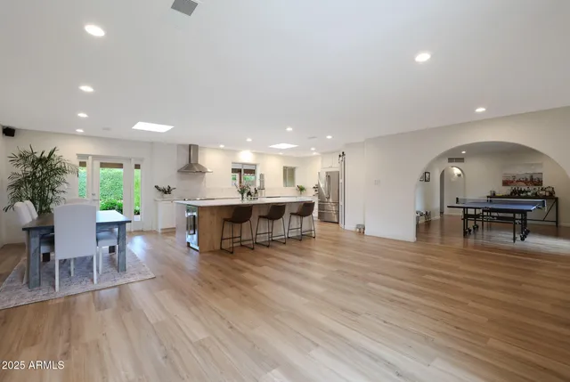 a view of a kitchen with dining room and wooden floor