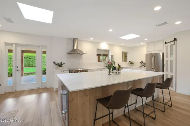 a kitchen with a dining table chairs and refrigerator