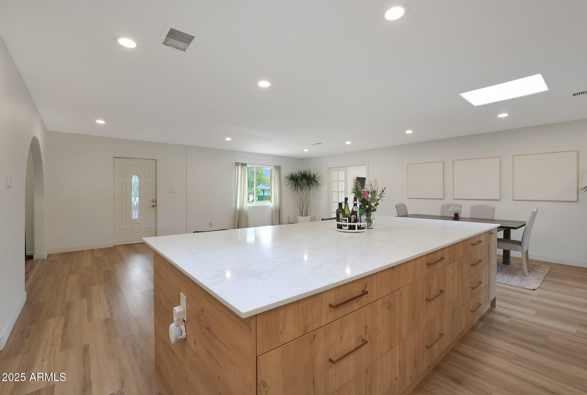 2226 East Fairmount Avenue Phoenix, AZ 85016 - Photo 9 of 50 a view of a kitchen island a sink wooden floor and a living room