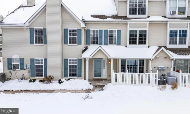 a front view of a house with a yard and porch