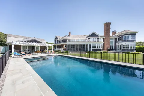 a view of a house with swimming pool and porch