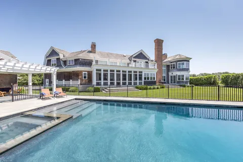 a view of a house with swimming pool and a yard