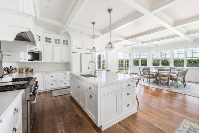 a large kitchen with cabinets and wooden floor