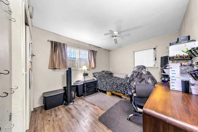 a bedroom with furniture and a wooden floor