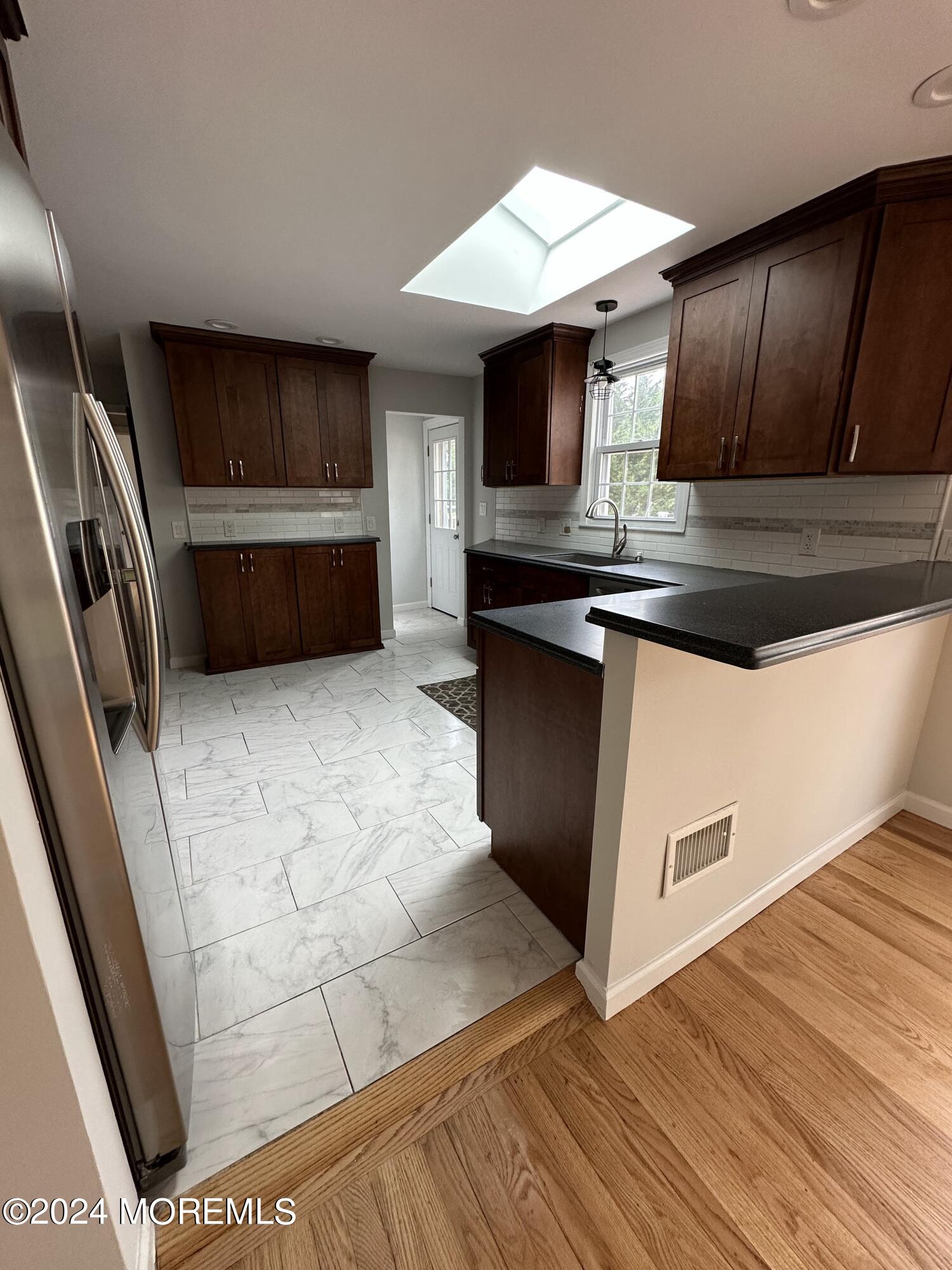 57 Kings Road Little Silver, NJ 07739 - Photo 8 of 22 a kitchen with stainless steel appliances granite countertop a sink and a stove top oven