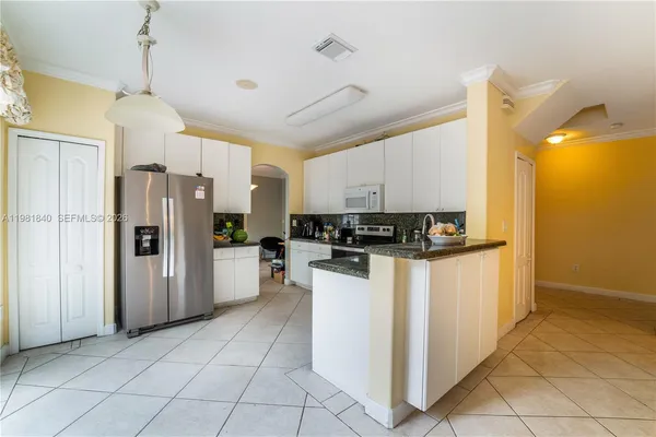 a kitchen with a refrigerator and a stove top oven