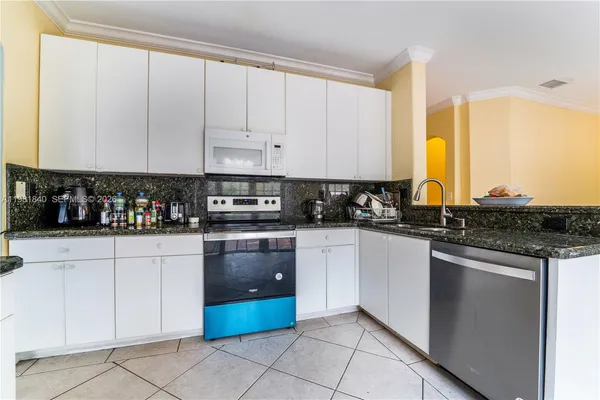a kitchen with stainless steel appliances granite countertop a sink and cabinets